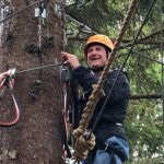 Volunteer climbing tree