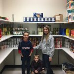 Katrina and her sons Ukiah and Logan in the East County HELP Food Pantry located at Toledo Jr. Sr. High.