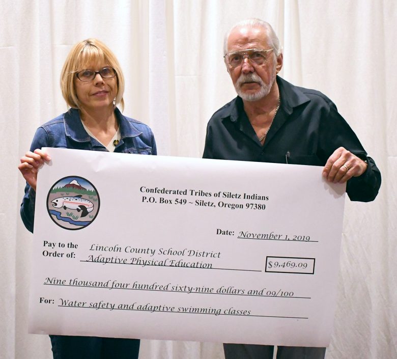 Connie Cradock of LCSD and Michael Holden of the Tribal Fund Hold Up Check