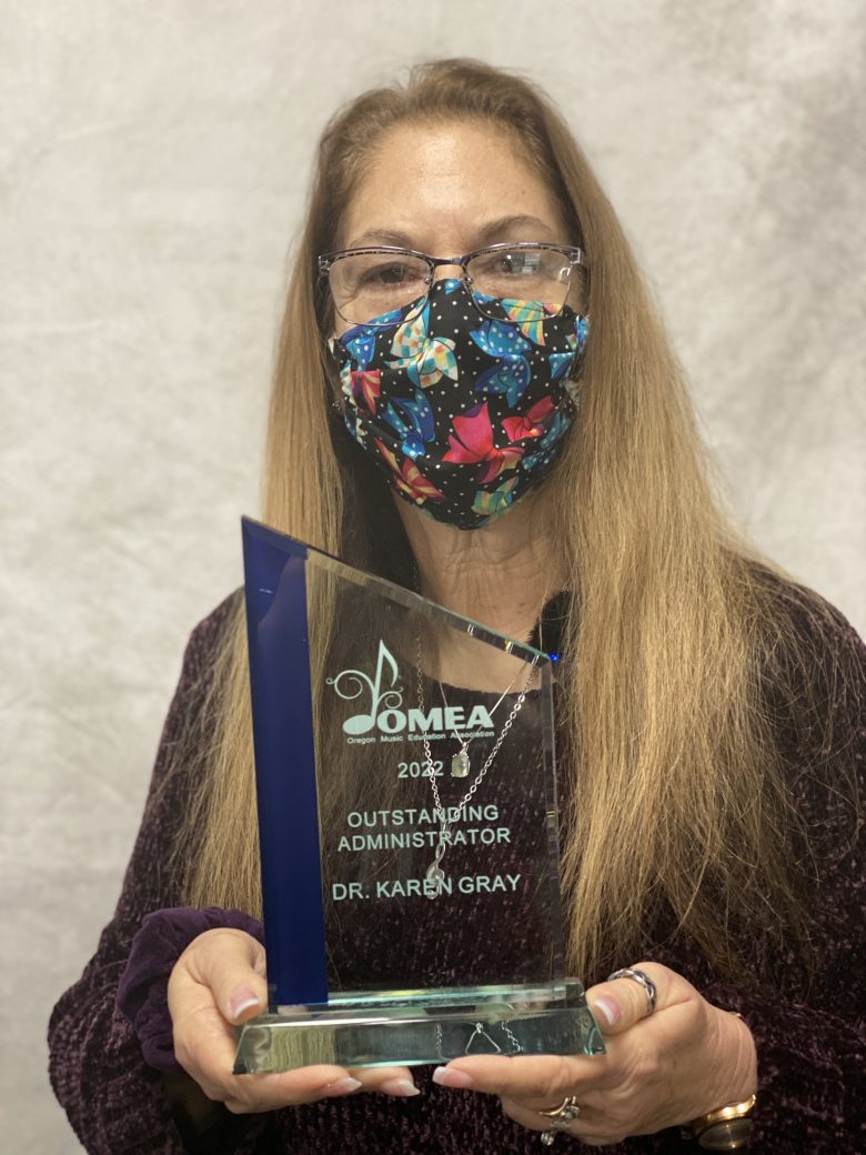 Karen holding OMEA award